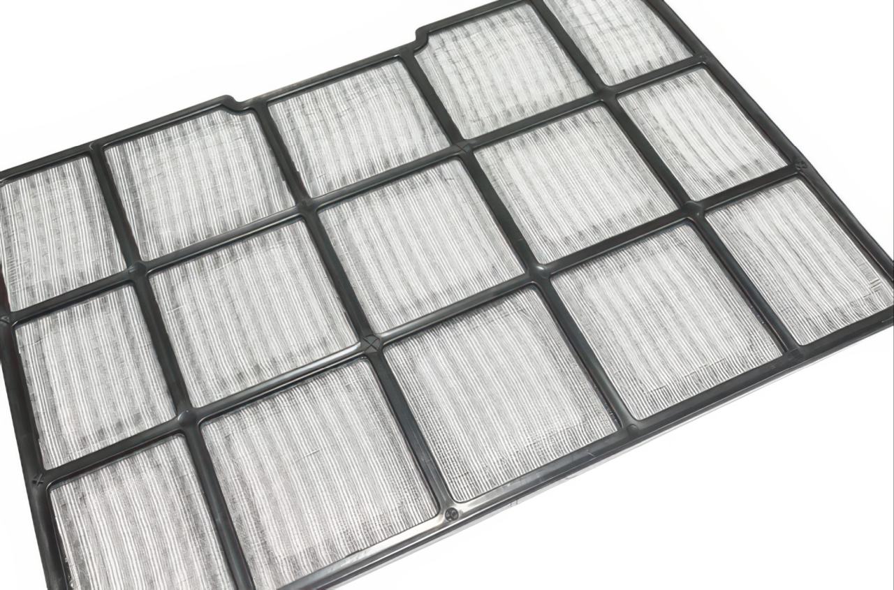 Rectangular air conditioning filter with black plastic grid frame containing multiple white pleated filter panels on white background.