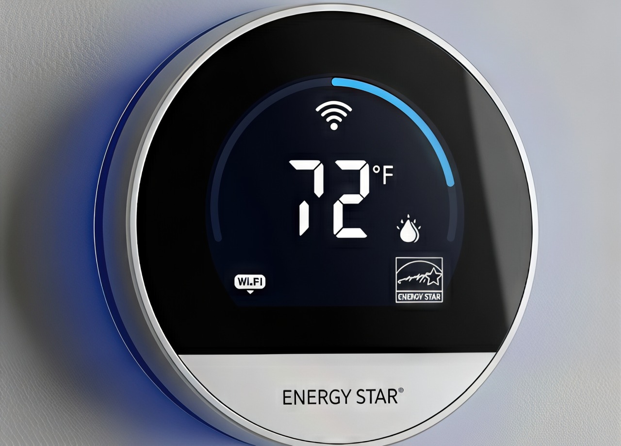 Close-up of a modern ENERGY STAR® smart thermostat displaying 72°F with Wi-Fi and humidity icons.