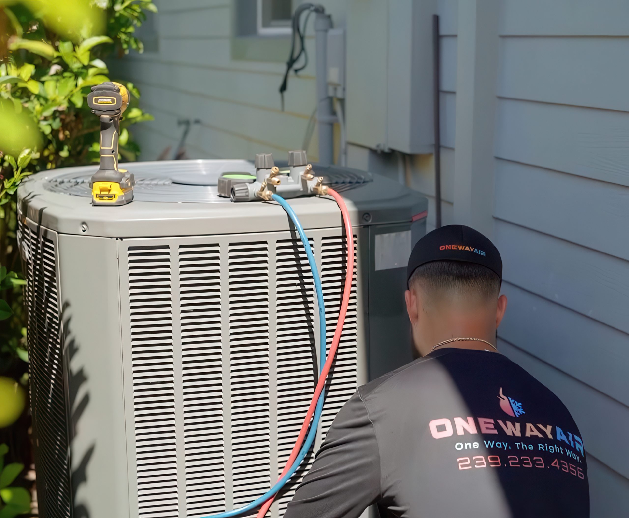 HVAC tech from ONEWAY AIR checks outdoor AC unit, showing typical service steps and AC repair cost in Tampa context.